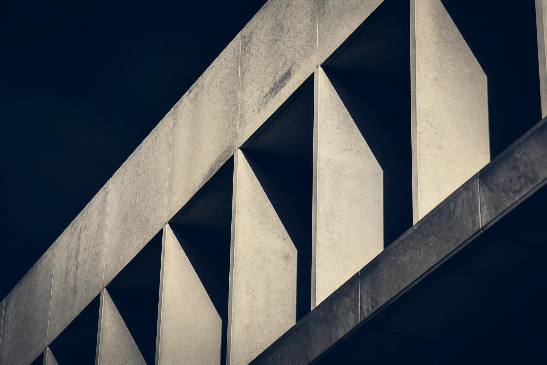 Abstract architectural facade in navy and stone